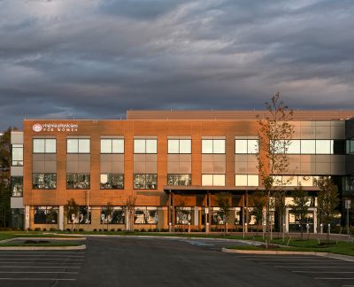 a large brick building with several windows and a sign that says Virginia Physicians for women