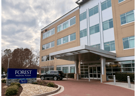 Front entrance of VPFW Henrico Doctors' office large tan building with Forest Medical Plaza sign with address 7611 Forest Ave