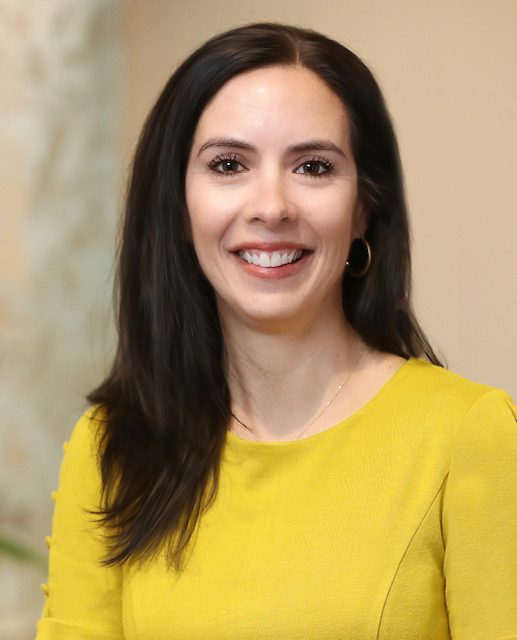 Dr. Nicole Kelleher, breast radiologist, smiling and wearing a yellow top