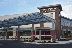 Front of VPFW Koger Center building with pink ribbon for grand opening