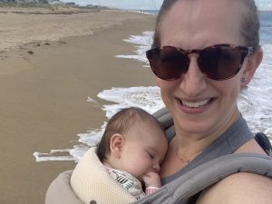 Dr. Cara Hartle hold her baby at the beach while discussing Formula, Breastfeeding, and Mental Health Resources for Richmond Area Moms
