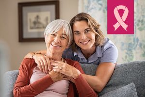 Woman and mom smiling and talking about breast health and when to get a mammogram
