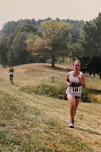 Dr. Draper running cross country on a hilly countryside in high school