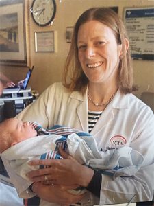 Dr. Neuman holding a baby