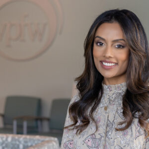 Dr. ANU ZAVELSKY M.D. OBGYN smiling with long brown hair