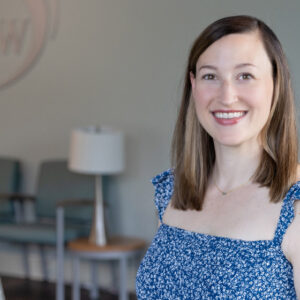 Dr. Carolanne Kondos OBGYN smiling with brown hair.