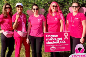 VPFW Mammogram Team at Making Strides Walk wearing pink in front of sign that says, "on your marks, get checked, GO."