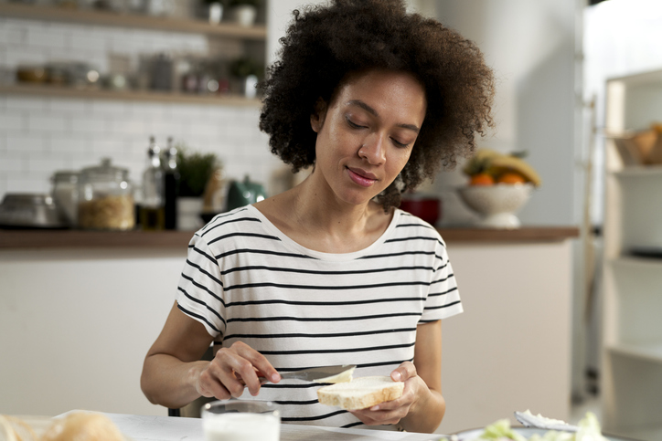 Pregnant woman in first trimester eating toast in the morning