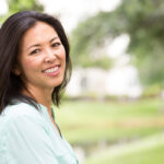 healthy middle aged woman smiling while walking outside