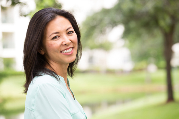 healthy middle aged woman smiling while walking outside